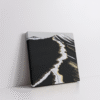 Modern abstract volcanic landscape wall art in a stretched canvas, featuring deep black textures, white glacier-like streaks, and shimmering metallic gold accents—luxury canvas print inspired by Icelandic terrain, perfect for bold, minimalist, Japandi, and high-contrast interiors. Ideal for statement wall decor and earthy-luxe aesthetics.