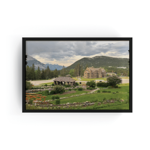Horizontal Banff cityscape print with black frame featuring panoramic mountain town view with stone buildings