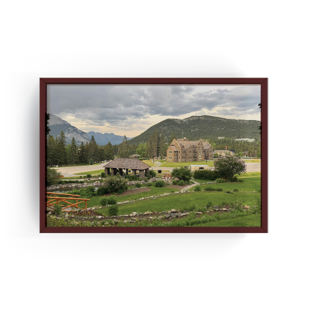 Horizontal Banff cityscape print with espresso frame capturing wide view of Banff with natural greenery