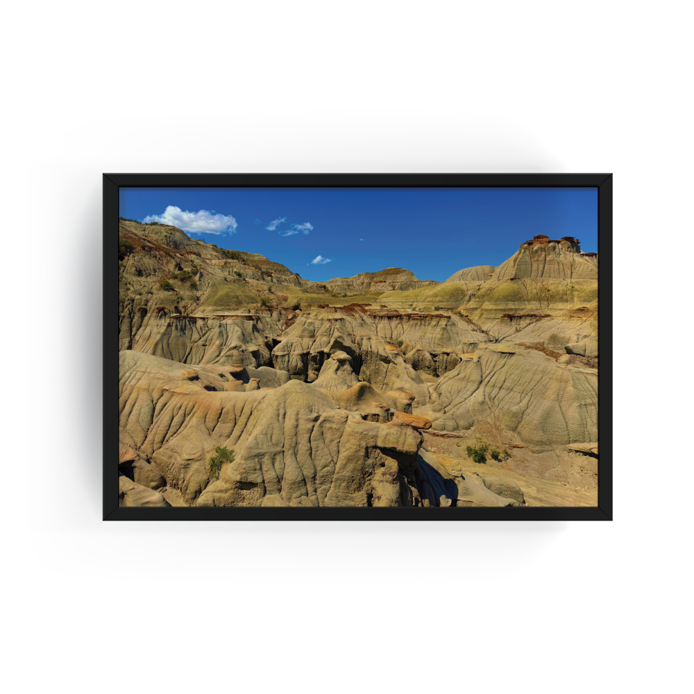 Horizontal black-framed photograph of expansive Badlands landscape at Dinosaur Provincial Park in Alberta.