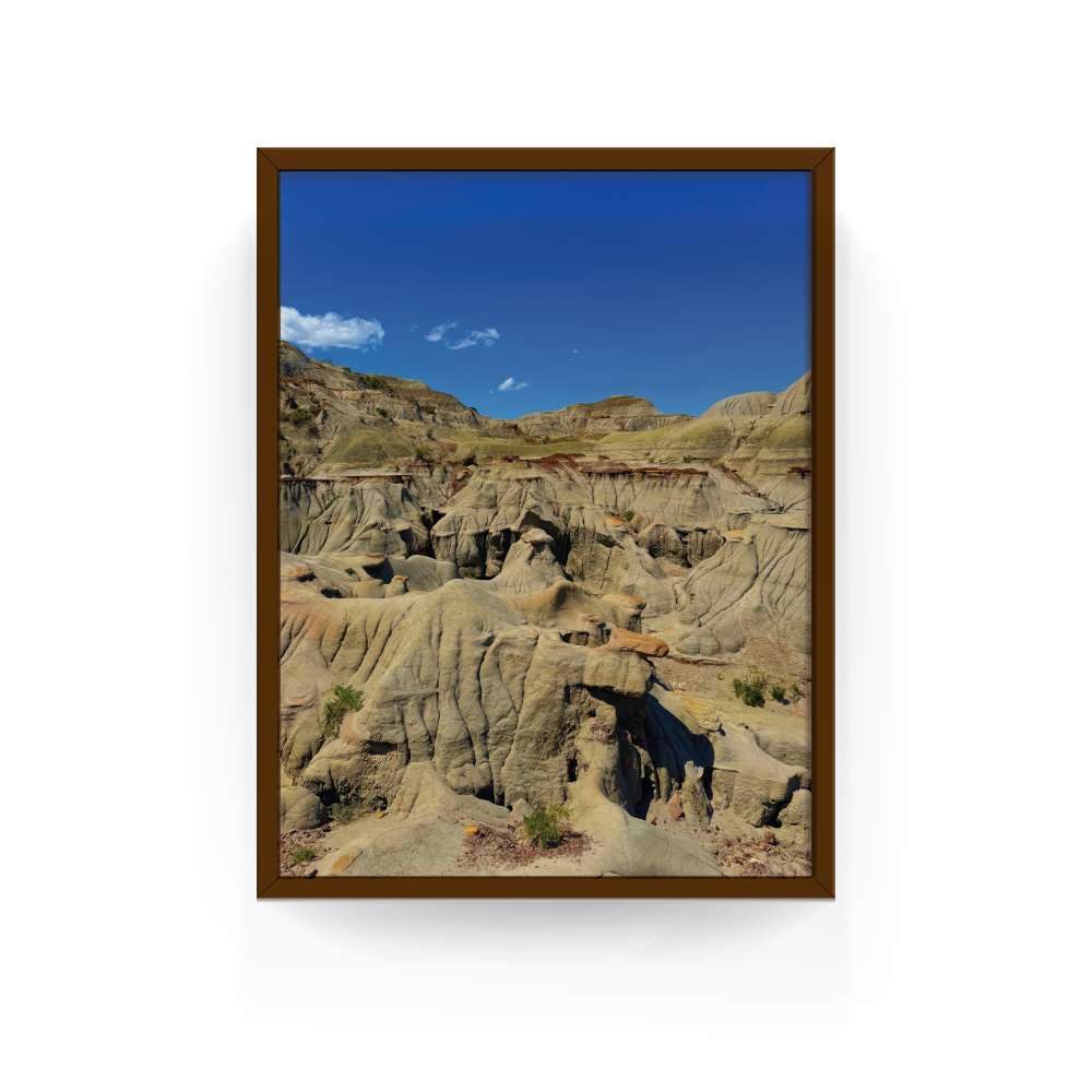 Vertical espresso-framed print of textured sandstone and deep canyons at Dinosaur Provincial Park, Alberta.
