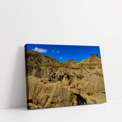 Horizontal stretched canvas view of Alberta’s Badlands with wide rock valleys and dramatic desert-like scenery.