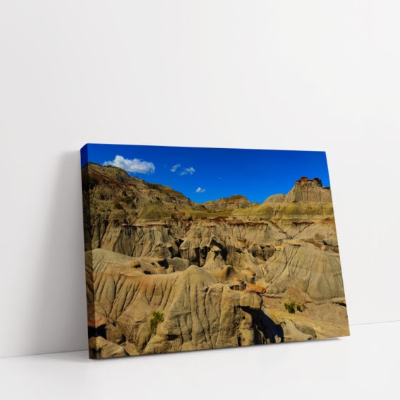 Horizontal stretched canvas view of Alberta’s Badlands with wide rock valleys and dramatic desert-like scenery.