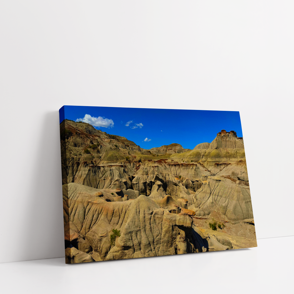 Horizontal stretched canvas view of Alberta’s Badlands with wide rock valleys and dramatic desert-like scenery.
