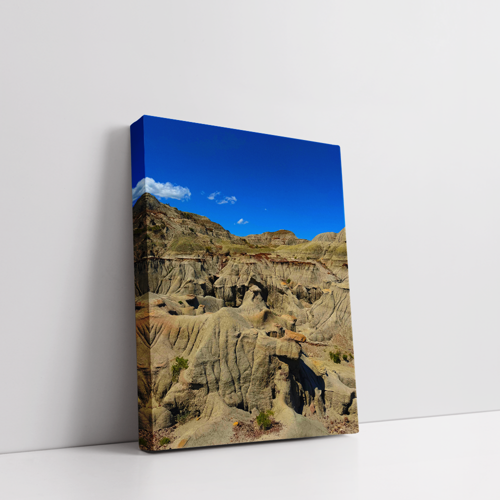 Vertical stretched canvas view of Dinosaur Provincial Park’s striking Badlands terrain with dramatic geological formations.