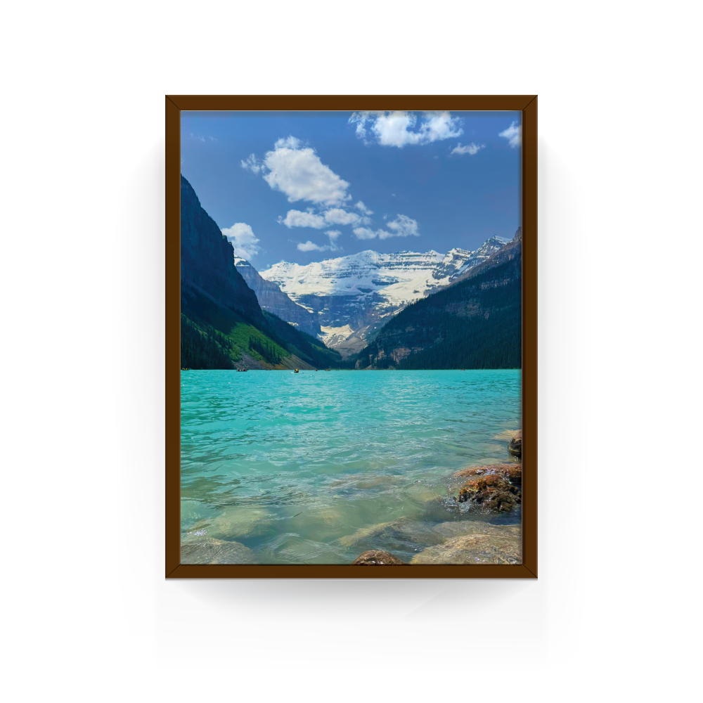 Espresso-framed photo of Lake Louise’s turquoise waters and Rocky Mountain scenery.