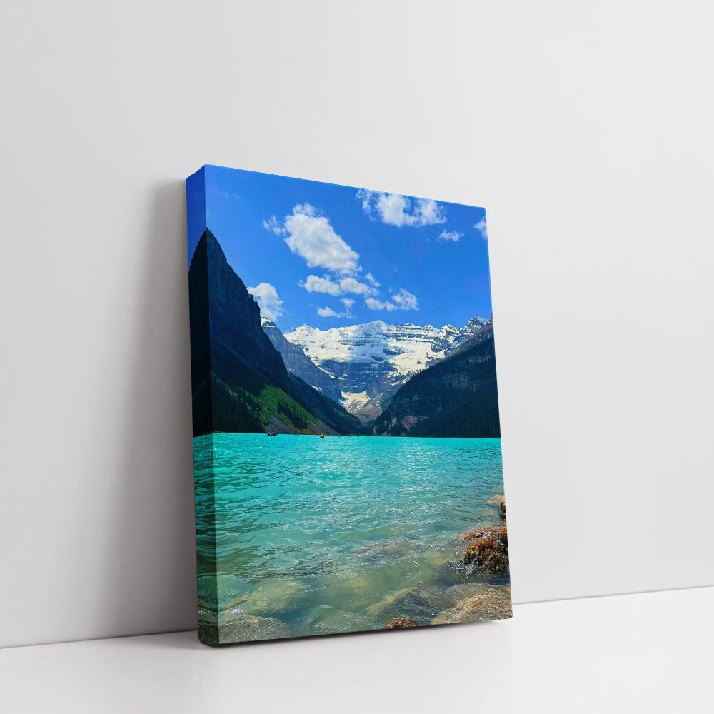 Stretched canvas print of Lake Louise with vivid turquoise lake and mountain peaks.
