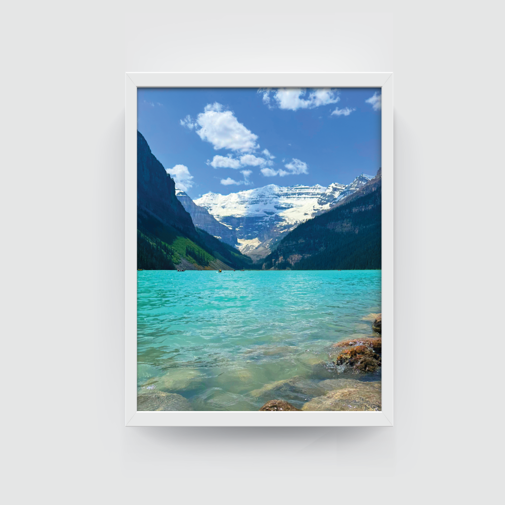 White-framed Lake Louise print with turquoise water, mountains, and pine forest in Banff.