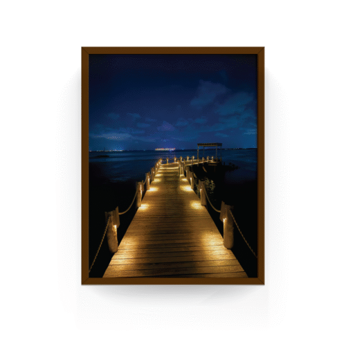 Espresso-framed Caribbean night pier print with glowing lights and ocean backdrop, Nizuc Resort.