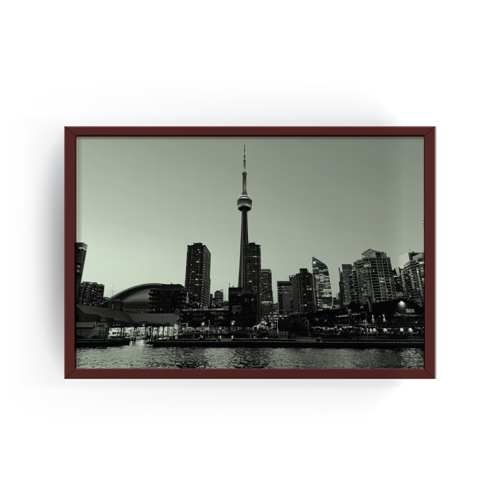 Espresso-framed monochrome Toronto skyline photo featuring CN Tower, Rogers Centre, and Ontario lake waters.