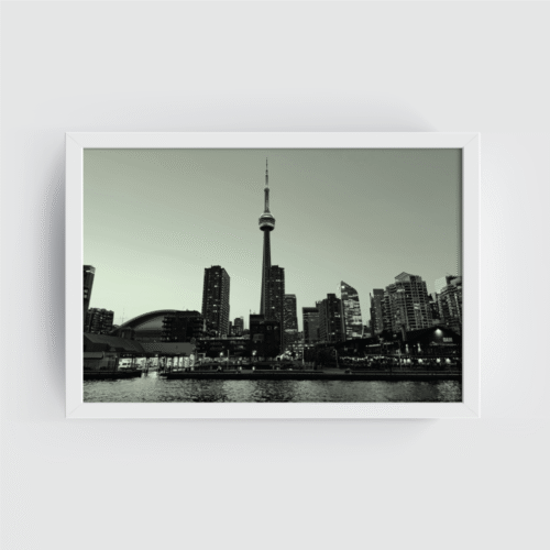 White-framed black and white Toronto skyline print with CN Tower, Rogers Centre, and lake foreground.