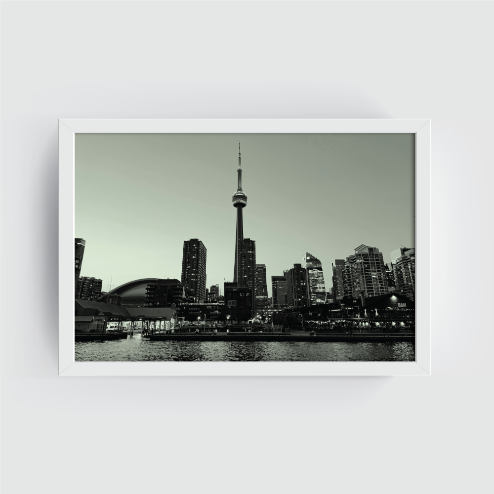 White-framed black and white Toronto skyline print with CN Tower, Rogers Centre, and lake foreground.