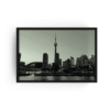 Black-framed black and white photograph of Toronto skyline with CN Tower and Rogers Centre, viewed from Lake Ontario.