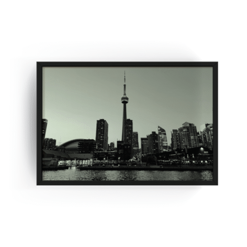 Black-framed black and white photograph of Toronto skyline with CN Tower and Rogers Centre, viewed from Lake Ontario.