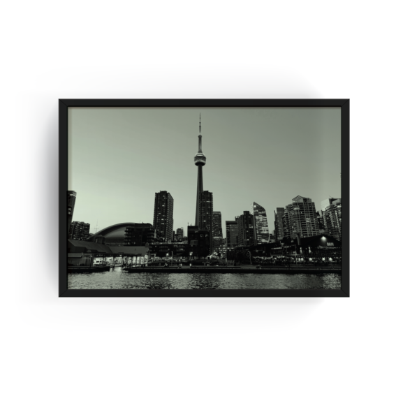 Black-framed black and white photograph of Toronto skyline with CN Tower and Rogers Centre, viewed from Lake Ontario.