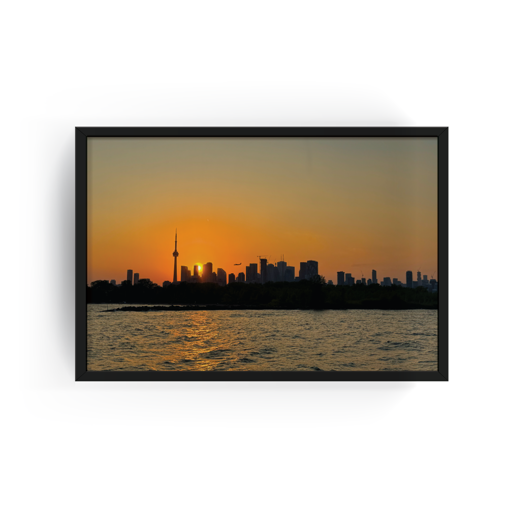 Toronto skyline at sunset photography in a sleek black frame, featuring the CN Tower and golden hour over Lake Ontario, perfect for modern cityscape wall art décor.