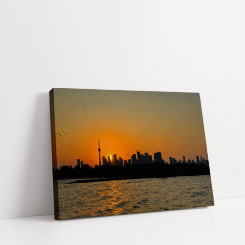 Toronto sunset skyline printed on premium stretched canvas, featuring the CN Tower, shimmering city lights, and golden hour colors over Lake Ontario.