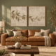 Two-piece olive branch canvas print set with realistic plaster relief effect in natural oak floating frames above a neutral living room sofa